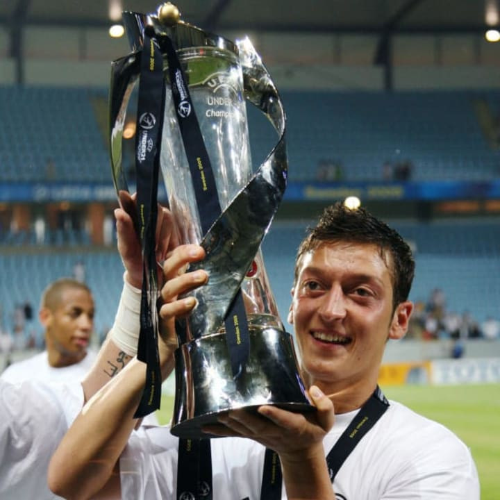 Germany's Mesut Ozil holds up the trophy